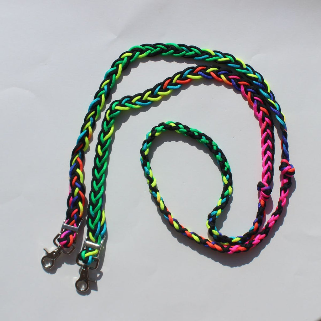 Braided nylon barrel reins with metal clasp hardware, shown in a vibrant multicolor pattern of neon green, pink, orange, yellow, and black