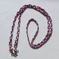 Braided rope barrel reins with silver metal hardware, featuring red, white, and blue strands
