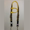 A yellow and black horse headstall with a candy corn pattern, featuring silver metal buckles, clips.