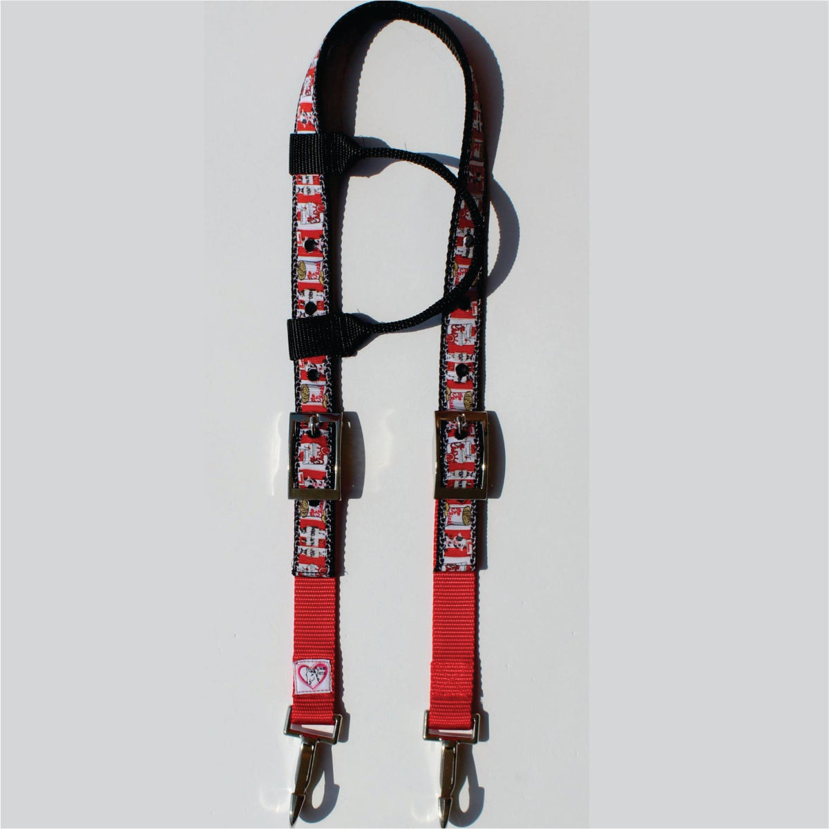 A red and black horse headstall with a chicken nugget pattern, featuring metal buckles