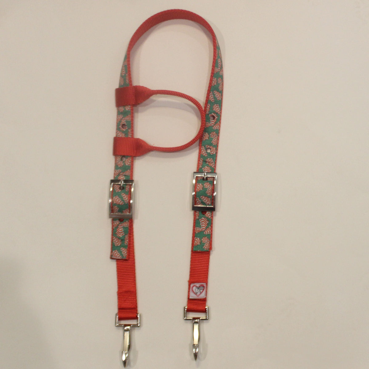 Red and green cookie pattern horse headstall with silver metal buckles and 