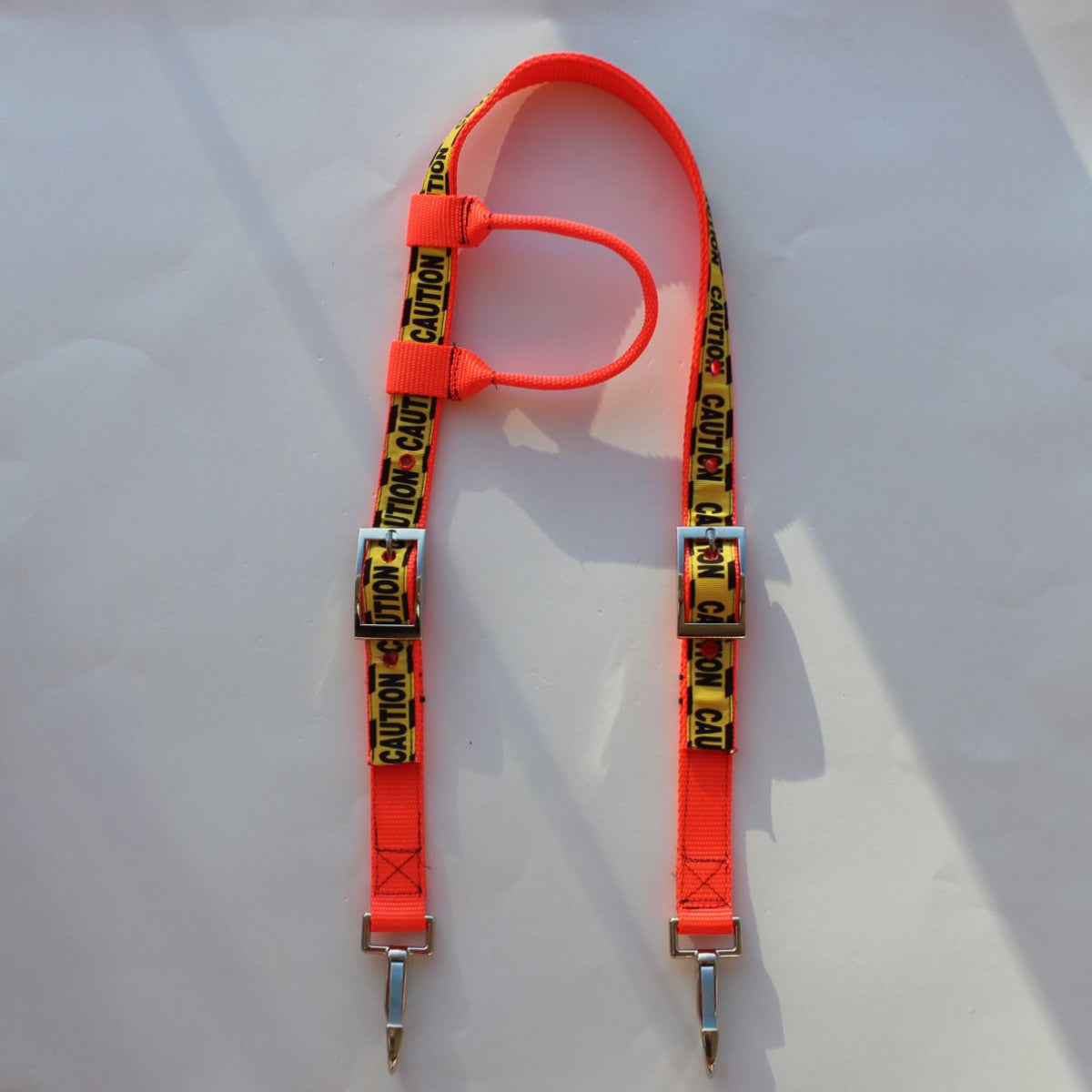 Bright orange safety horse headstall with yellow and black caution tape printed straps and silver metal clips