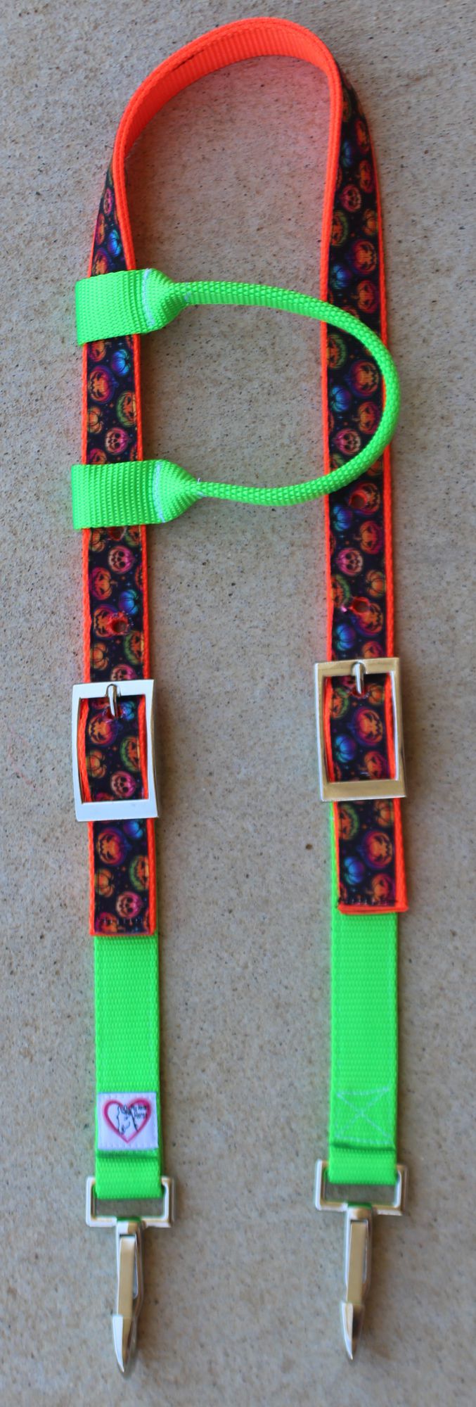 A neon green and orange headstall with a neon pumpkin strap, silver-tone buckles, and silver-tone metal clips
