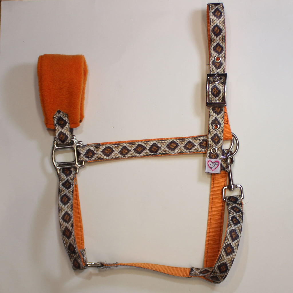 An orange and patterned horse halter with a matching orange and rattlesnake pattern, and a padded orange noseband.