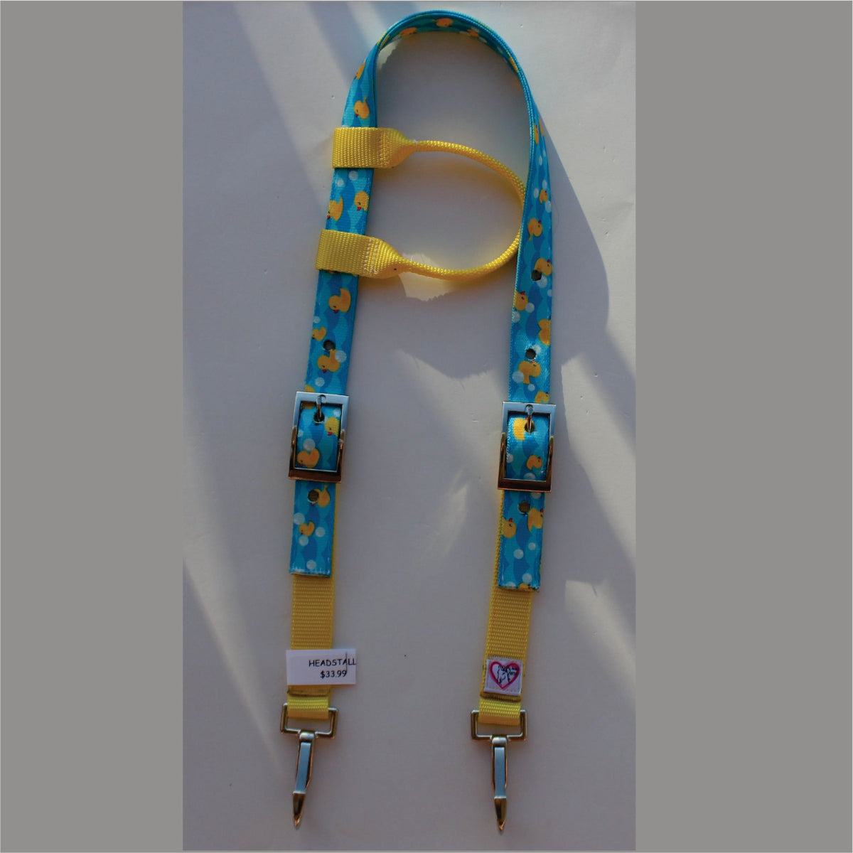 A blue and yellow rubber duck horse headstall. 