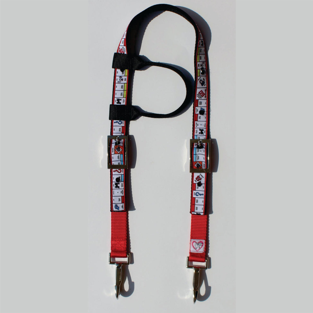A red and black horse headstall with a printed pattern of playing cards, featuring metal hardware 