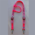 A neon pink horse headstall featuring a printed pattern of hearts, stars, and the word 'spoiled' on the webbing, finished with silver metal buckles and clips.